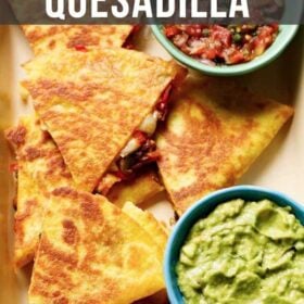 veggie quesadilla triangles served in a tray with a side of guacamole and salsa with text layovers.