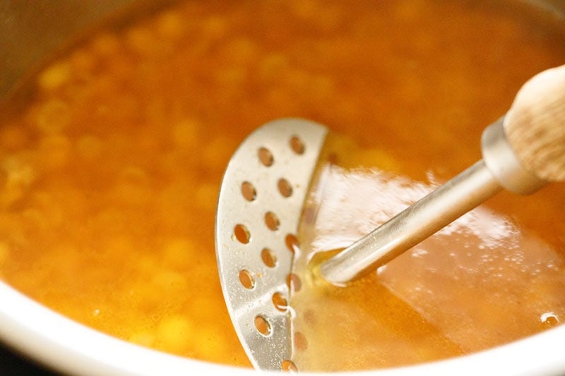 mashing cooked dried white peas