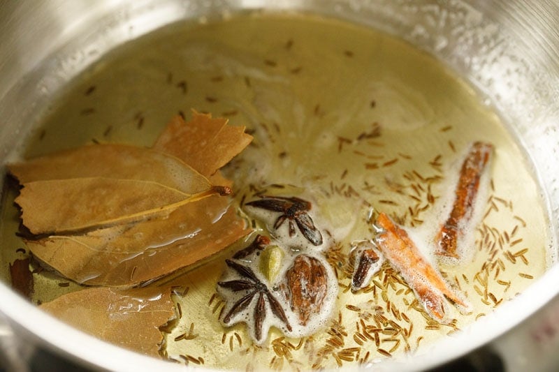 tempering spices in ghee for  for making meal maker biryani gravy. 