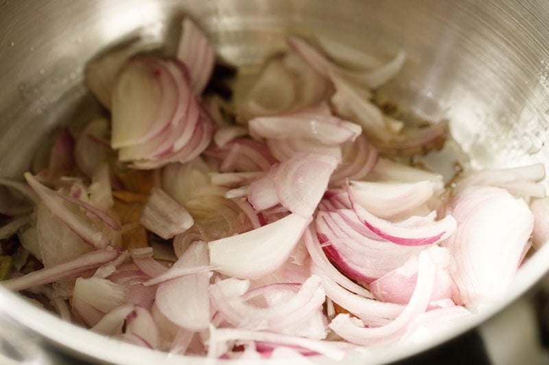 onions added to tempered spices  for making meal maker biryani. 