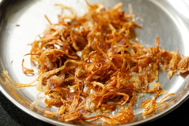 half the fried onions in the pan for making meal maker biryani. 