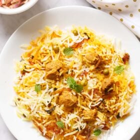 soya biryani in a white plate garnished with some mint sprigs