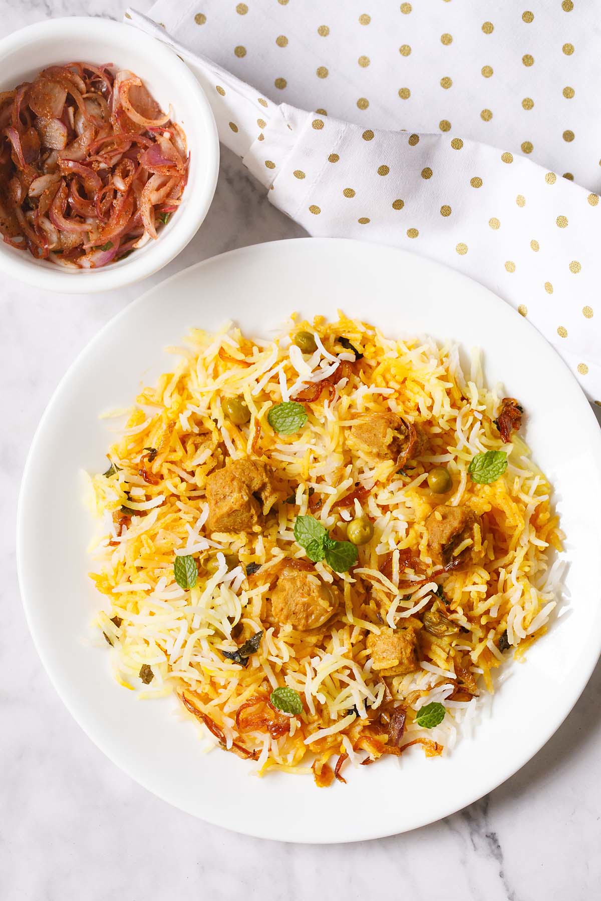 soya chunks biryani garnished with mint leaves on a white plate