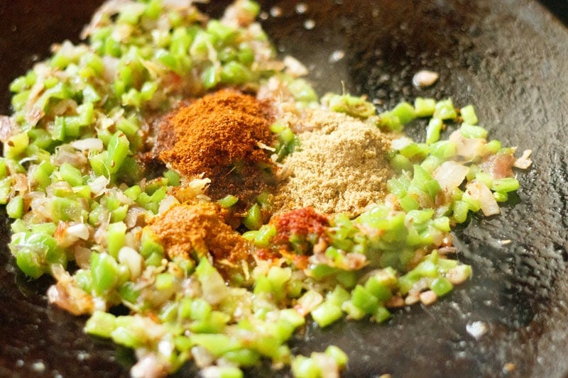 ground spices on capsicum and onion mixture