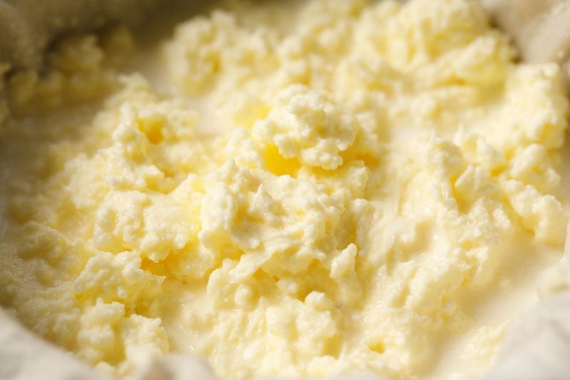 homemade butter in a lined mesh strainer