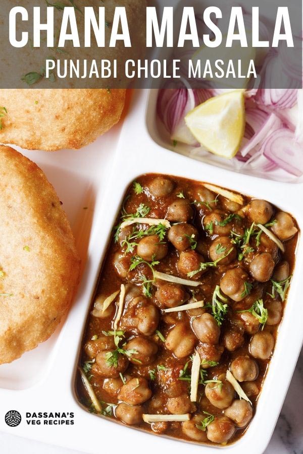 overhead shot of white plate with sections filled with chana masala, sliced onions, fresh lime wedges and bhatura on a marble table-top with text layovers