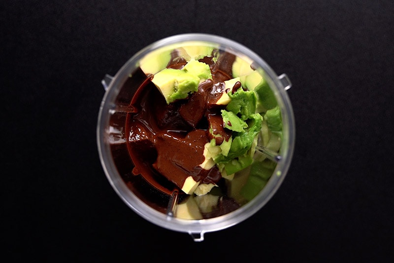 room temperature chocolate mixture, vanilla extract and avocado in a blender