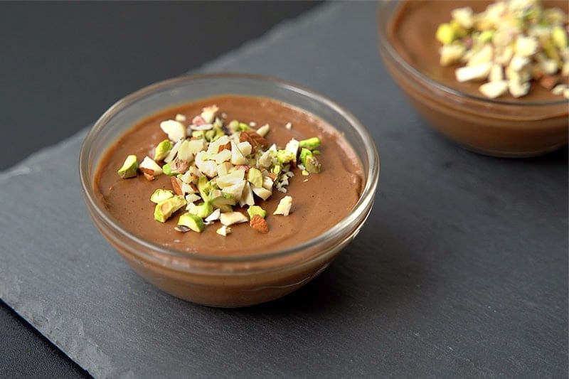 avocado mousse served with chopped nuts and berries