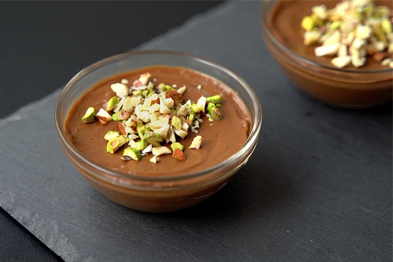 avocado mousse served with chopped nuts and berries