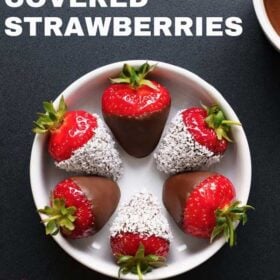 overhead shot of chocolate covered strawberries in a white bowl on black board with text layovers