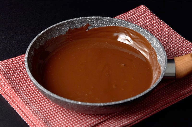 melted chocolate in a pan atop a kitchen towel