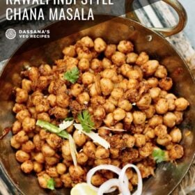 overhead shot of pindi chana in a metallic wok garnished with onion slices, cilantro, lemon wedge and green chilli strips with text layovers