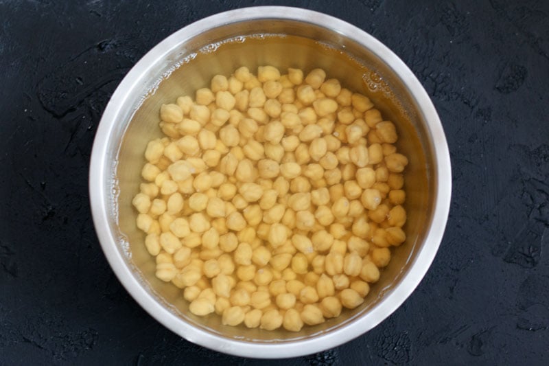 soaked chickpeas in water in a bowl.