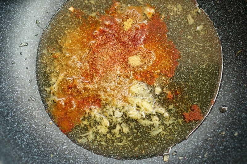 adding spices to ginger garlic paste