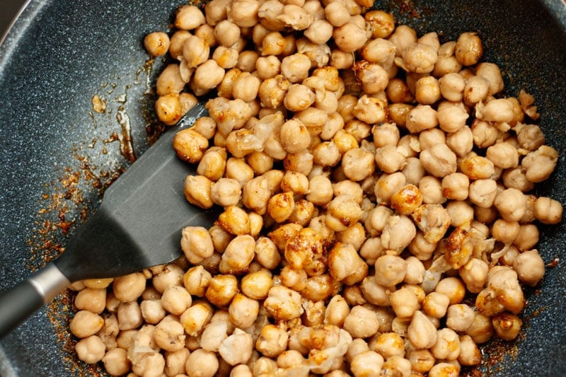 mixing chickpeas with the masala
