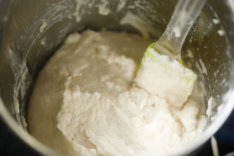 lentil batter with a spatula for scraping the side in a blender