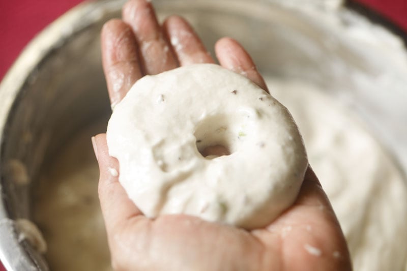 prepared a doughnut shape from the vada batter on the palm