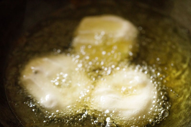 shaped vada being fried in oil