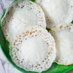four appam on a green plate