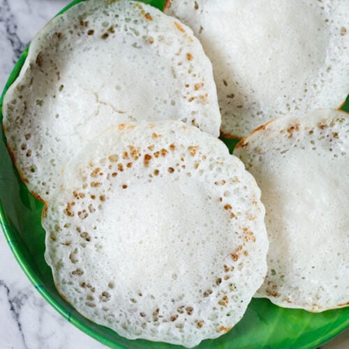 four appam on a green plate