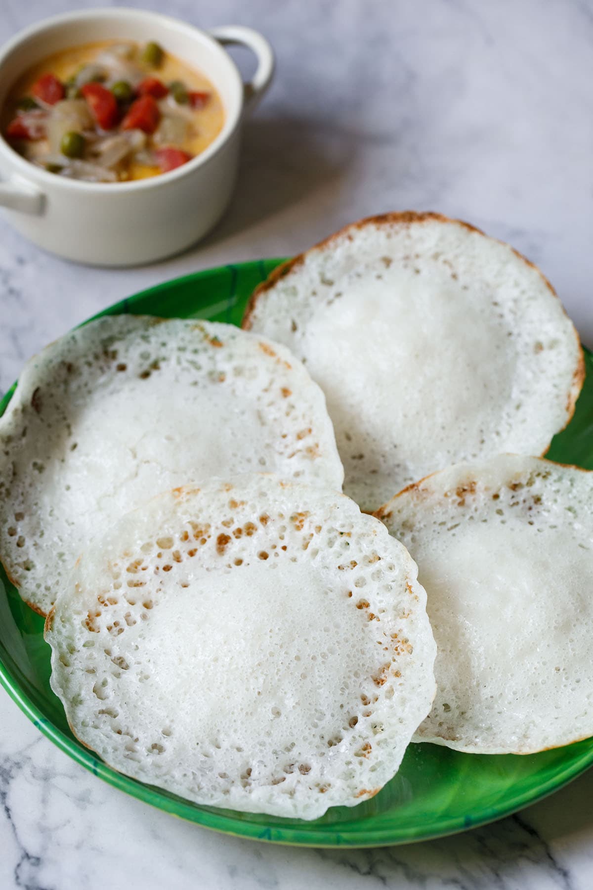 four appam on green plate