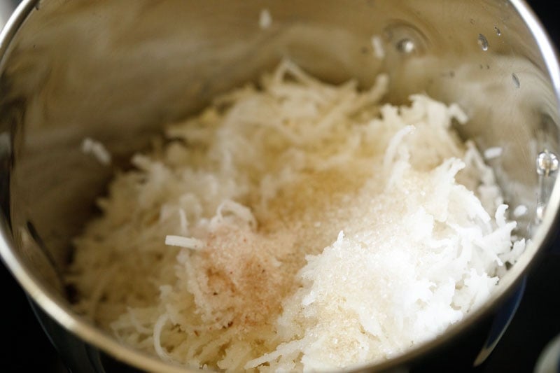 rice in blender jar with coconut, pha, salt and sugar