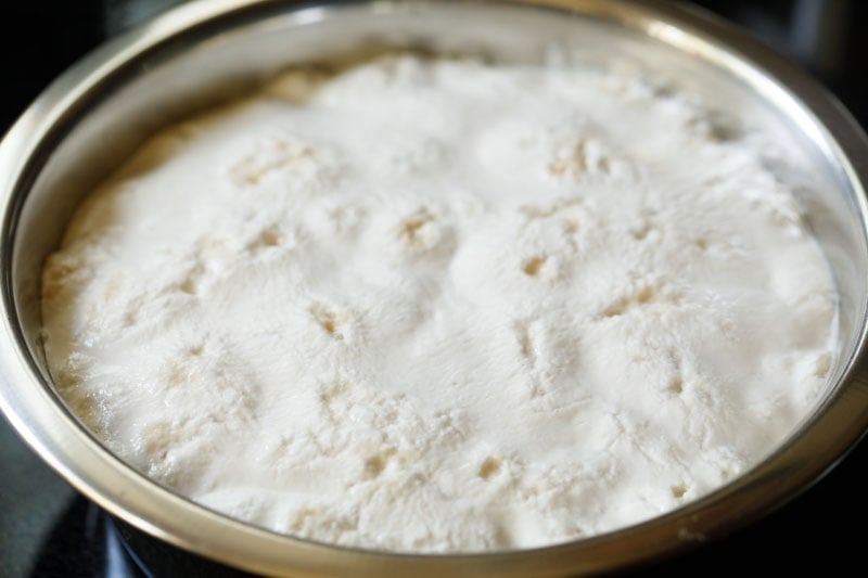 properly fermented dough in a mixing bowl - it has doubled in size and has lots of air pockets