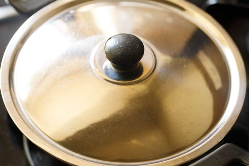 lid atop pan on the flam