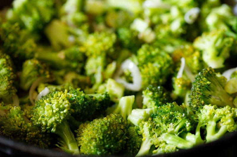 stir-frying broccoli in wok