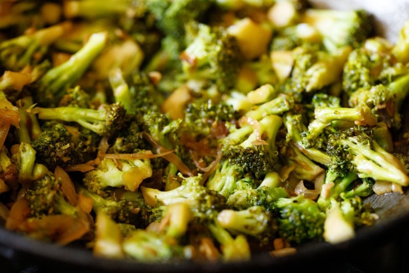 stir fried broccoli in a wok