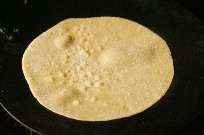 roasting chapati on tawa