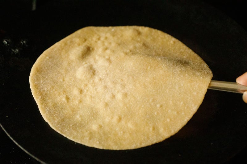 lifting chapati with spatula