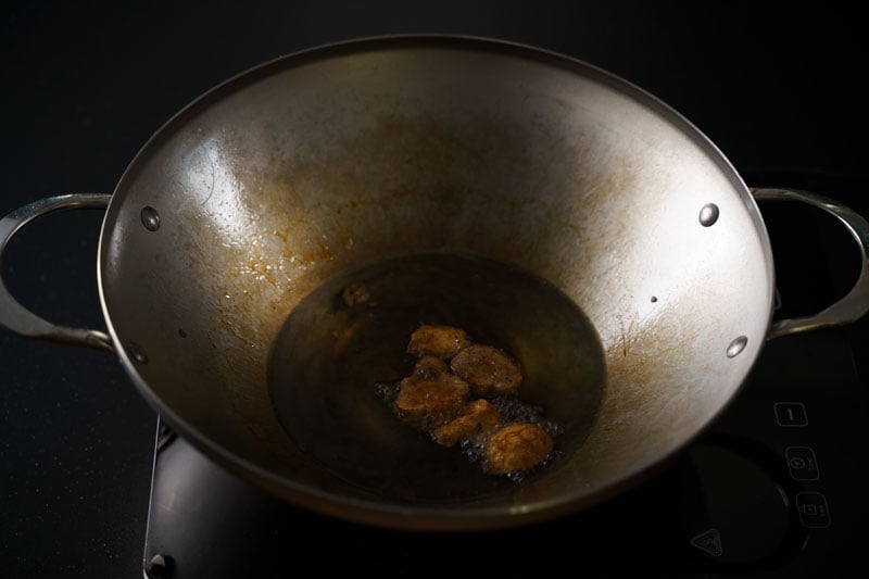 golden fried mushrooms in hot oil in wok