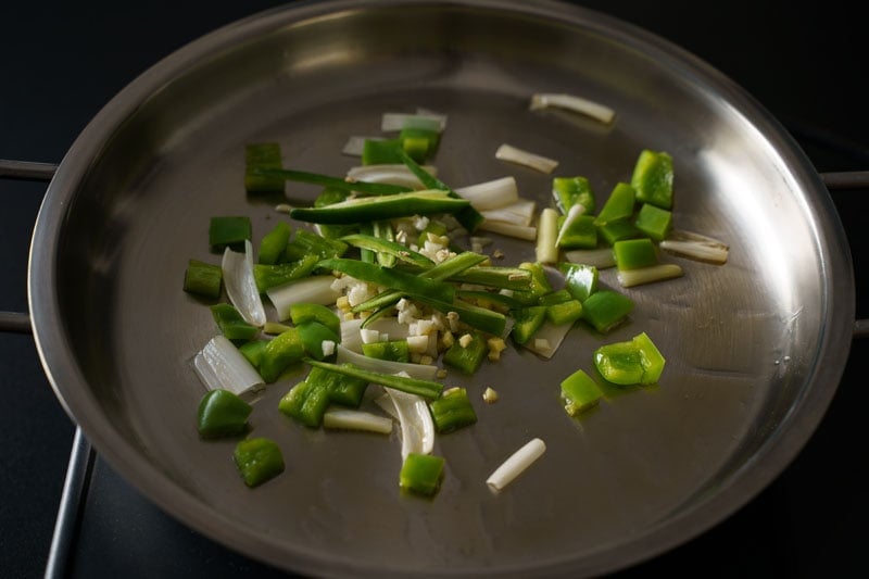 ginger, garlic and green chilies on scallion whites and capscium