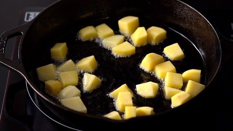 potato cubes cooking in oil