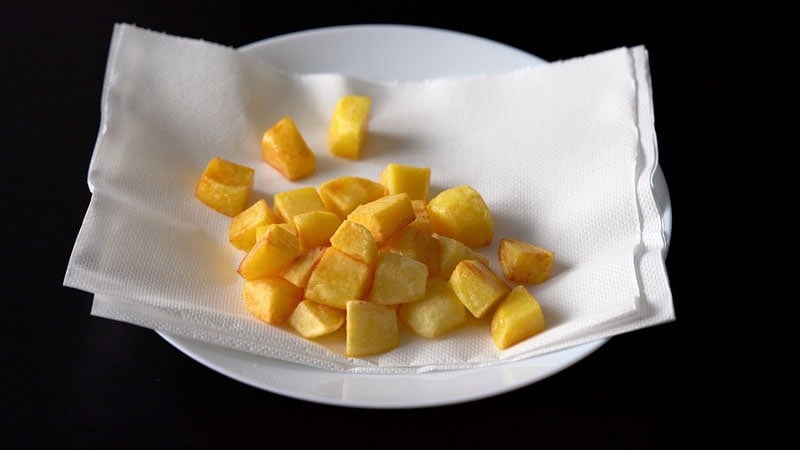 fried potato cubes on a paper towel