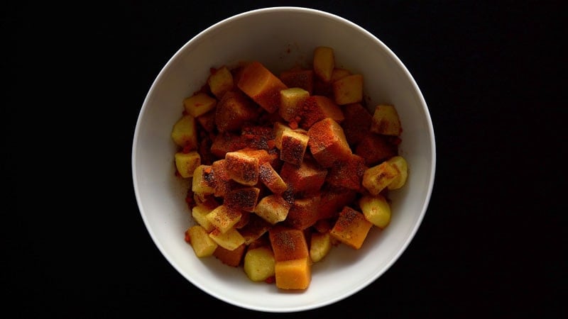 cumin powder, chaat masala, black salt and red chilli on fruit and tubers 