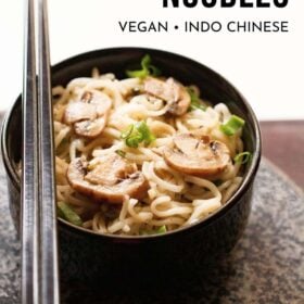 mushroom noodles with black chopsticks placed on top of black bowl on a round grey black granite board with text layovers.