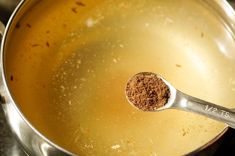 chaat masala powder being added to lemonade mix