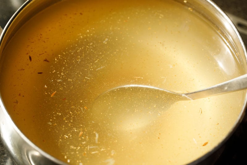 stirring nimbu pani to dissolve the sugar