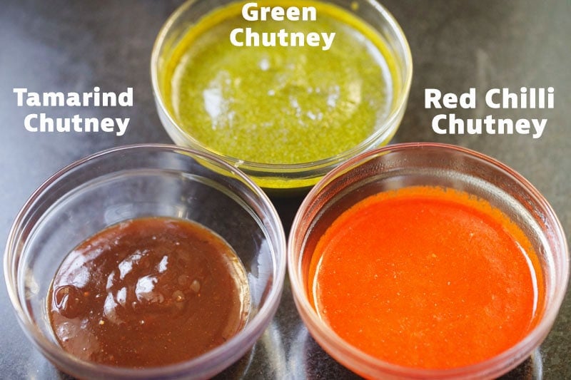 green, tamarind and red chutney in bowls