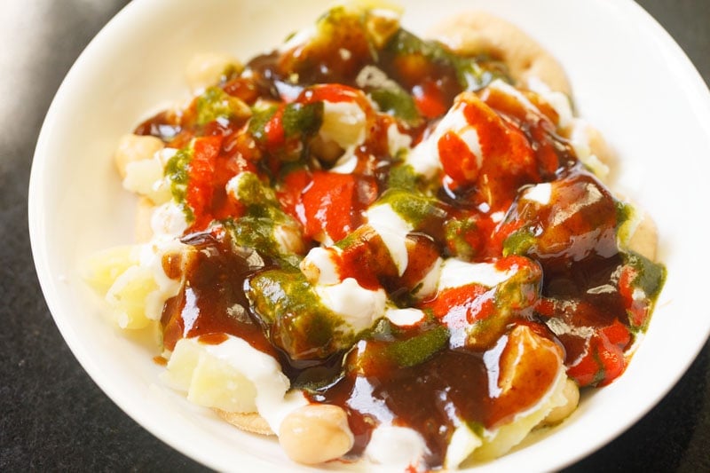 chutney, curd, chickpeas and potatoes in a plate