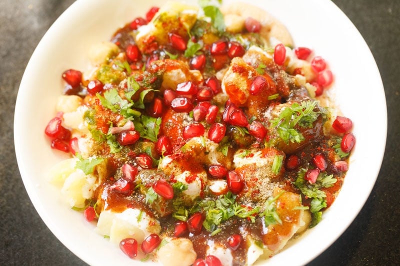 papdi chaat garnished with coriander and pomegranate seeds