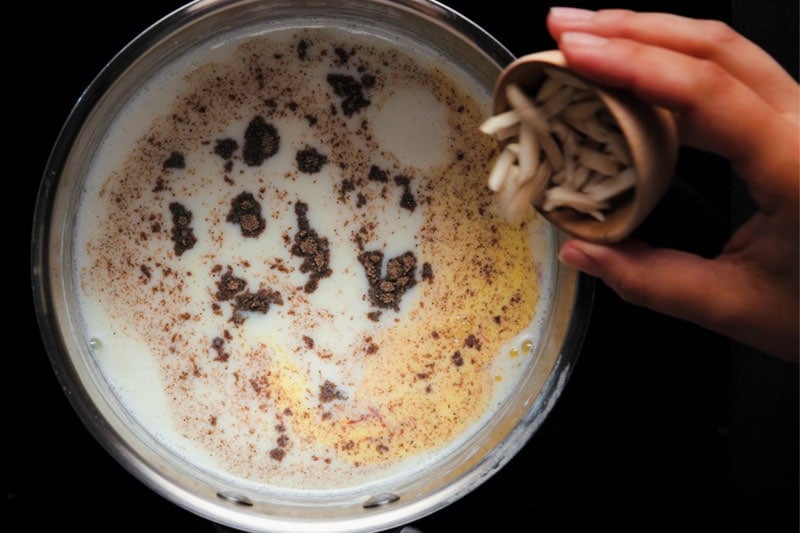 almond sliver being added to milk