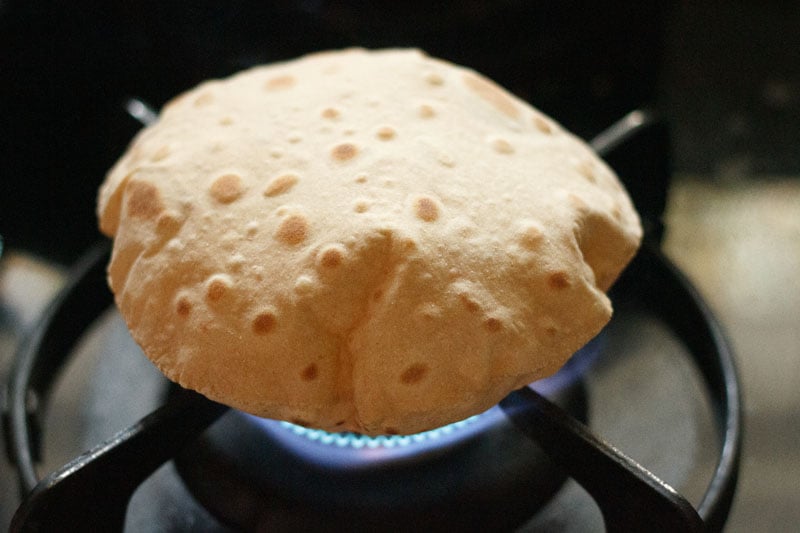 roti phulka placed on direct flame has puffed up and is filled with air
