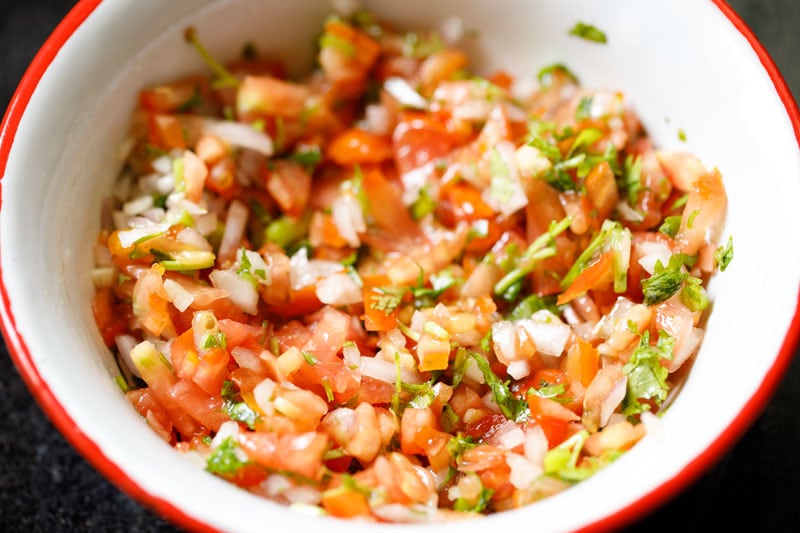 Finished pico de gallo in a red-rimmed bowl