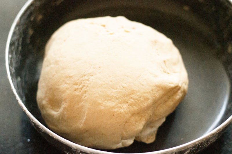 soft and smooth roti dough in a black bowl