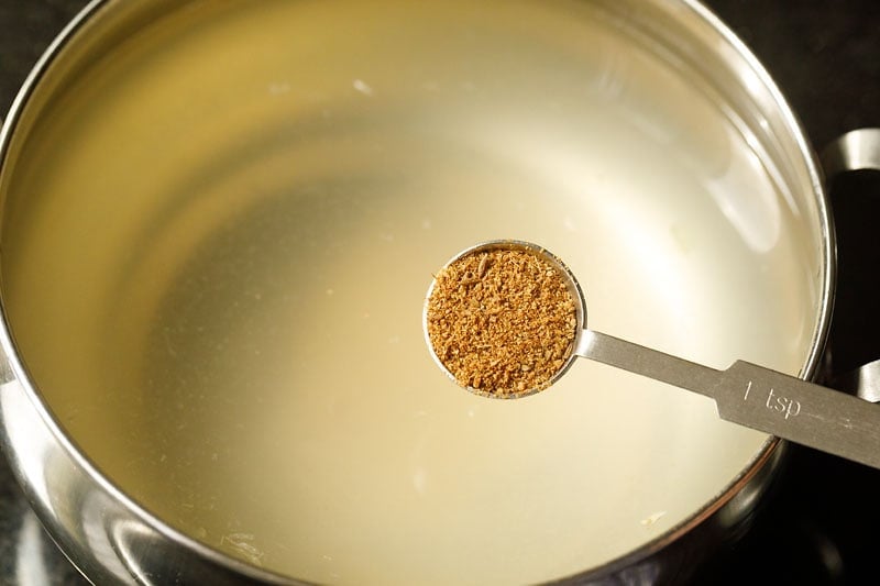 adding cumin powder to Indian lemonade