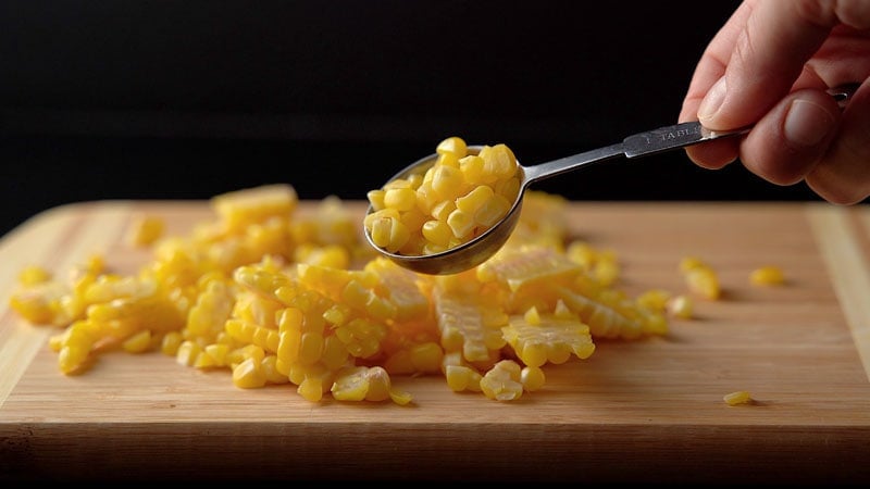 a tablespoon filled with corn kernels