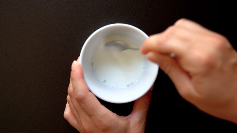 cornstarch and water being mixed with spoon